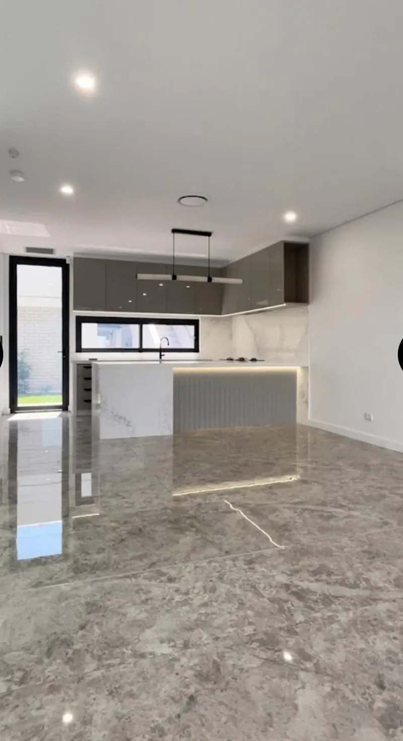 Open-plan kitchen and living area with crisp white walls and ceilings