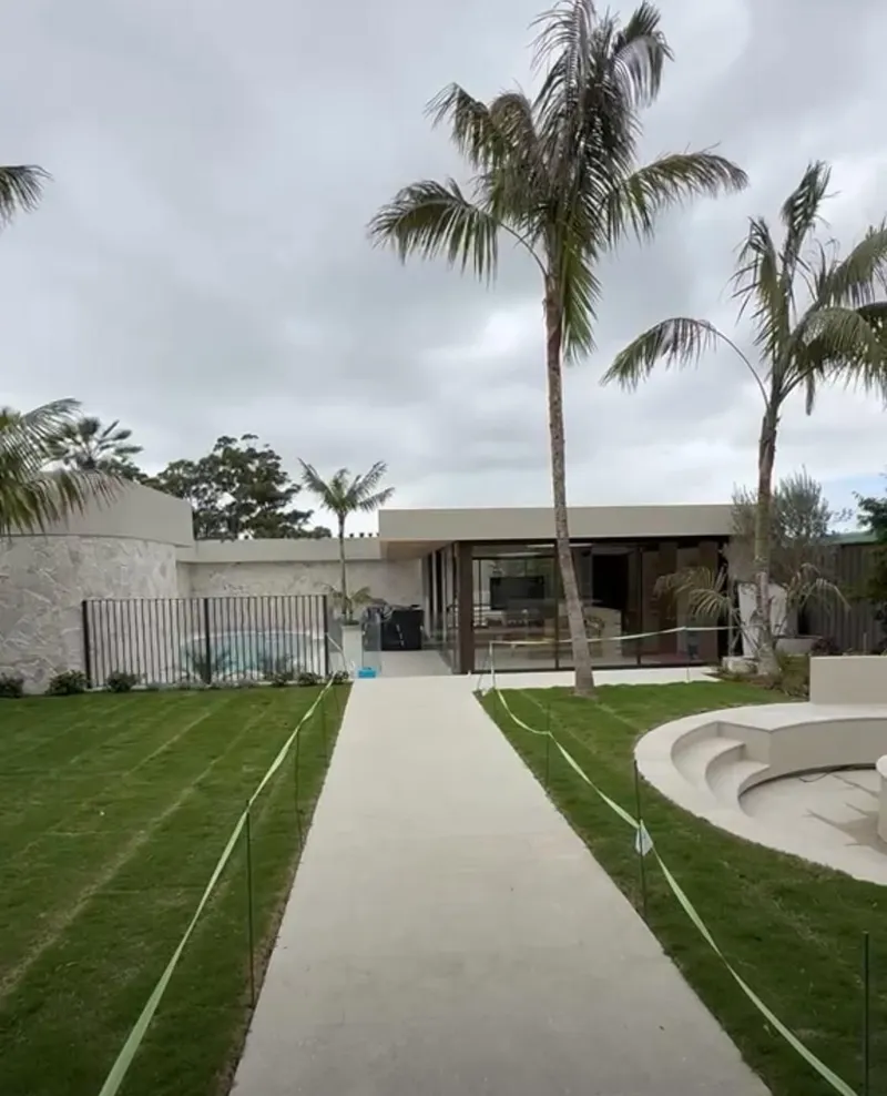 Path through the lawn to a row of new single-storey villas